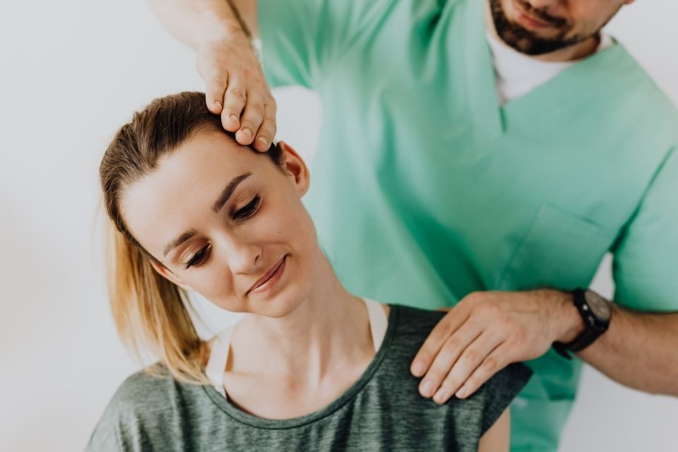 Chiropractor performing a spinal adjustment on a patient
