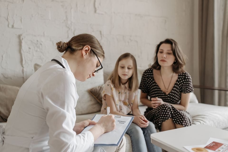 Family physician consulting with a patient in a primary care clinic