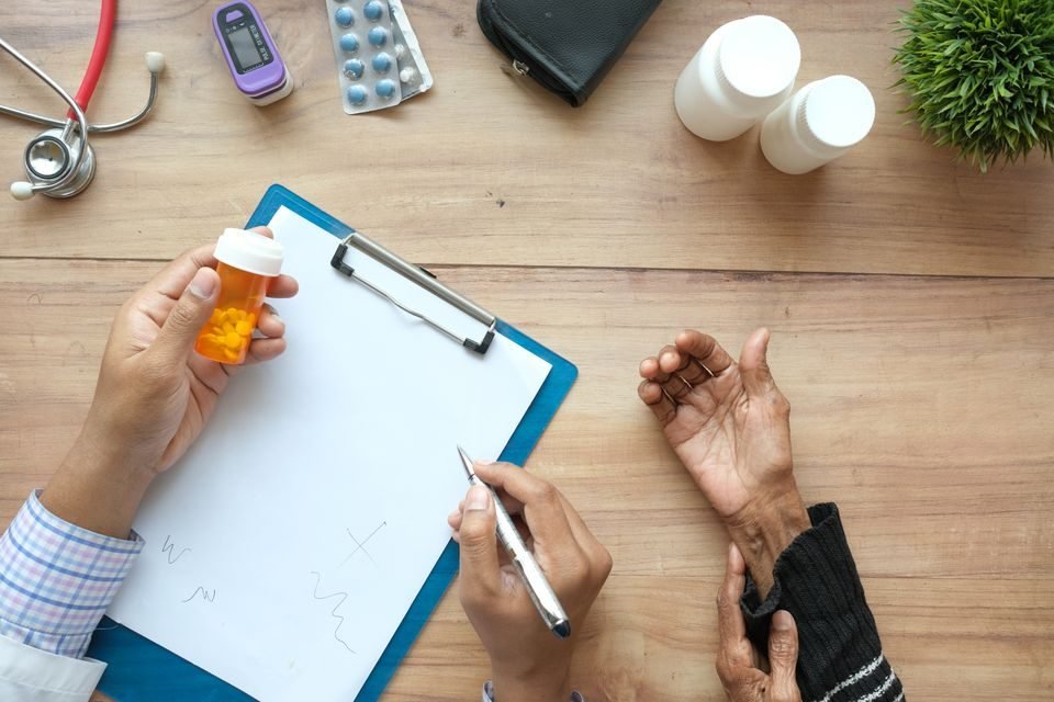 Internist reviewing chronic conditions with an older adult patient