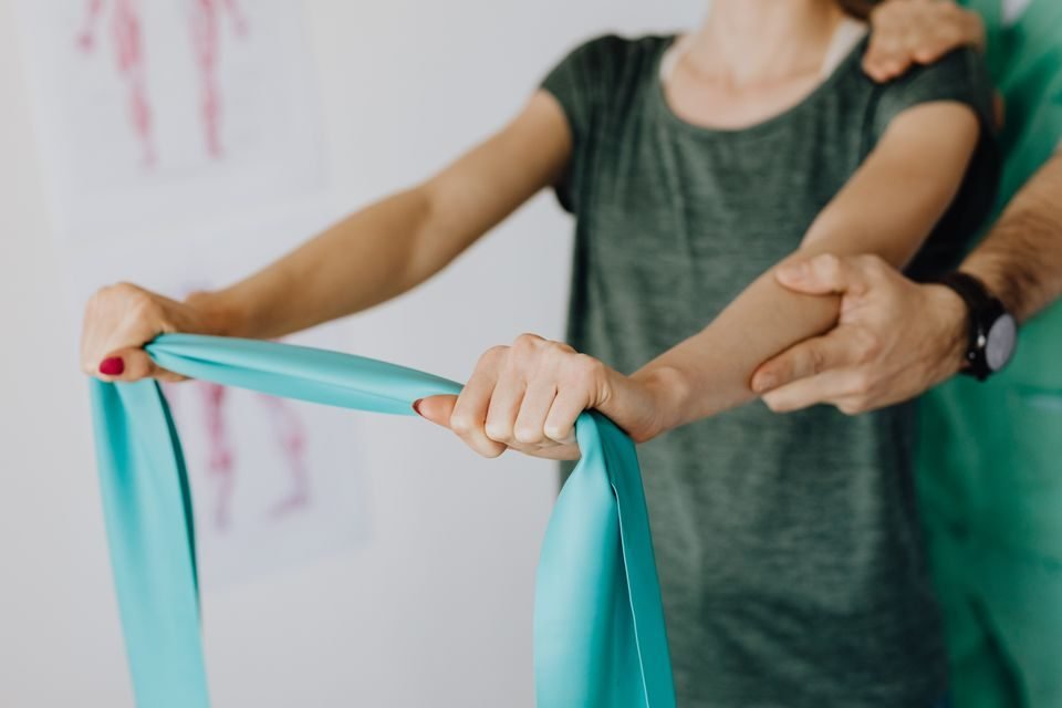 Physical therapist guiding a patient through a rehabilitation exercise