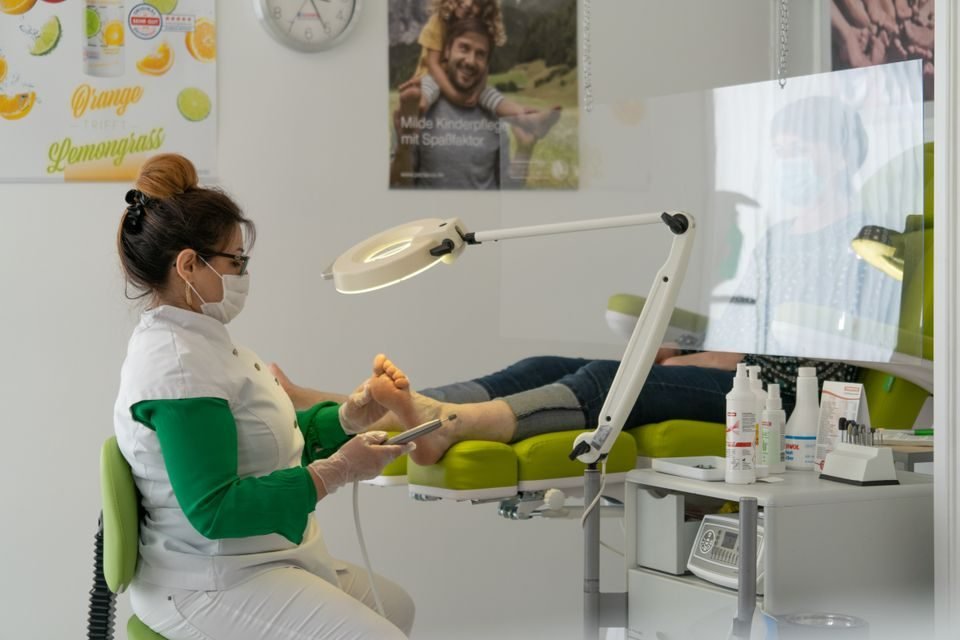 Podiatrist examining a patient foot during a clinic visit