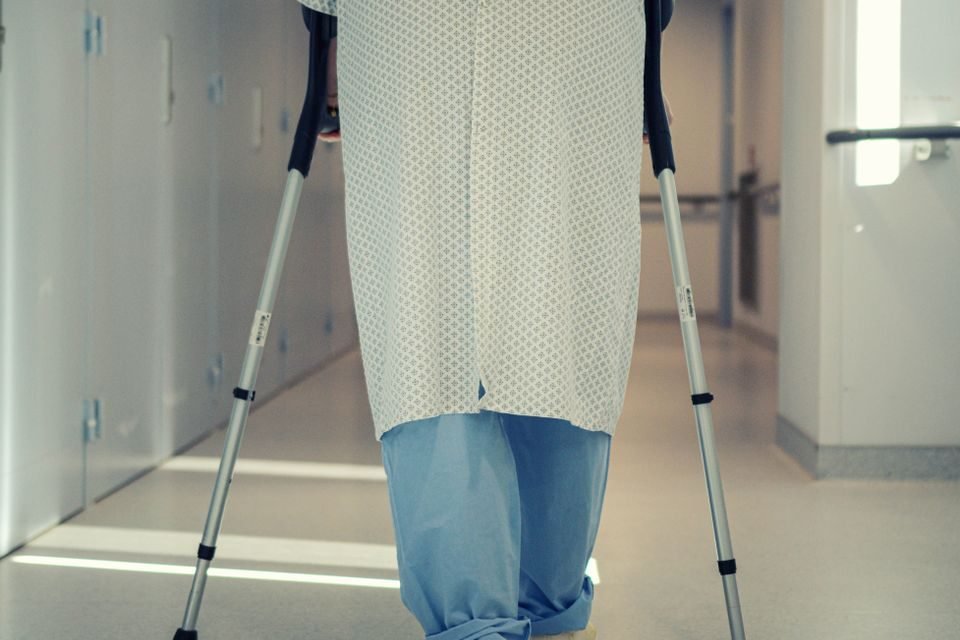 Rehabilitation therapist supporting a patient with mobility training