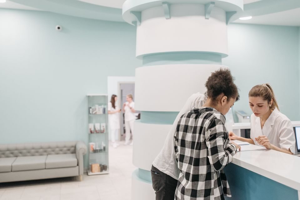 Front desk staff verifying a patient insurance eligibility at check-in